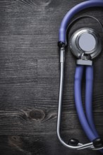 Medical stethoscope on wooden background top view medicine concept