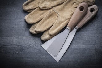 Two steel paint scrapers and pair of working gloves