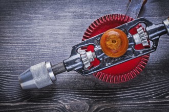 Vintage hand drill on wooden board