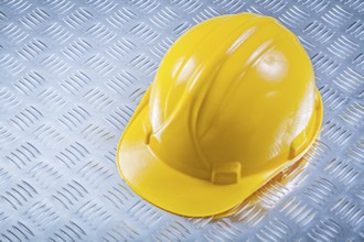 Safety building helmet on grooved metal plate construction concept
