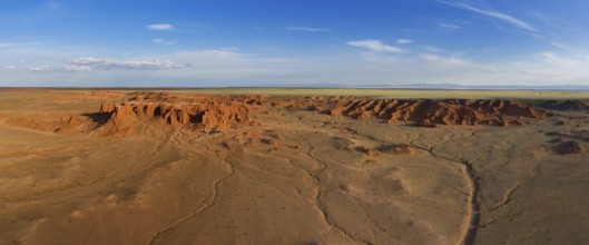 Aerial panorama view of the Bayanzag flaming cliffs at sunset in Mongolia, found in the Gobi Desert