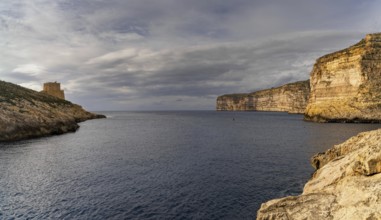 A view of the Xlendi Bay watchtower and cliffs on the coast of Gozo Island in Malta
