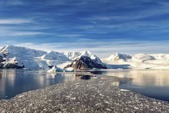 Vast glaciers and icebergs stretch out under a clear, bright blue sky, The landscape of Antarctica