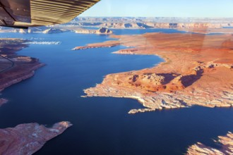 Landscape under the wing of an airplane. Lake Powell is a reservoir on the Colorado River located