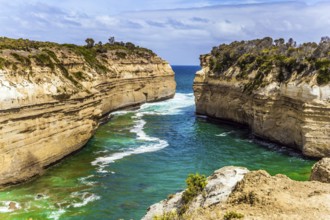 The Great Ocean Road of Australia. Coastal rocks are composed of sandstone. Small ocean fjord with