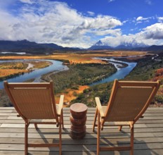 Two wooden chairs - on a wooden platform. Charming rural idyll. Clouds reflected in the smooth