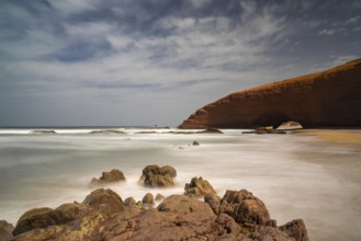 A long exposure view of the beach and rock arch at Legzira on the Atlantic Coast of Morroco