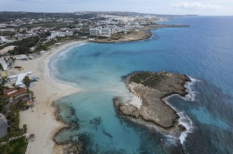 Aerial drone view of the coastline of empty beach in winter. Summer holidays. Nissi beach bay Ayia
