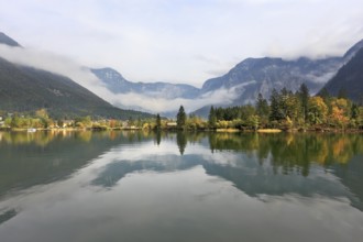 The picturesque shores of Lake Hallstatt. Mountains reflected in the smooth water of the lake