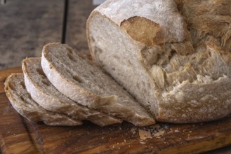 Sliced organic wheat bread and flour on a table.Alsace, France