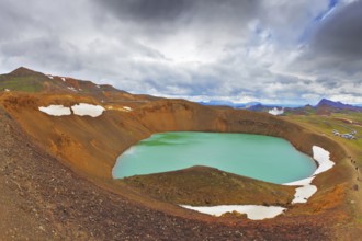 July in Iceland. Lake in the crater of an extinct volcano. Lake water bright green color. On the