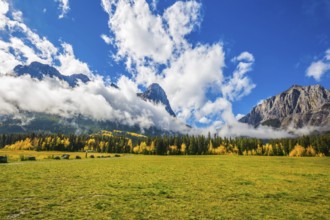 Shining sunny day in Canmore. Concept of hiking. The Three Sisters mountains in the Canadian