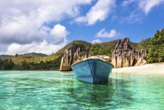 Old fishing boat on Tropical beach at Curieuse island Seychelles. Horizontal shot