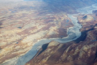 Landscape of Greenland seen from the air in summer with rocky surface, lakes and ground moraine,