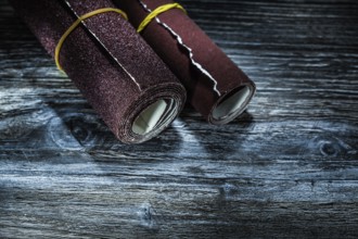 Rolled sandpaper on vintage wooden board