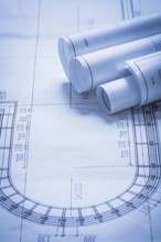 Rolled up construction plans building and architecture concept
