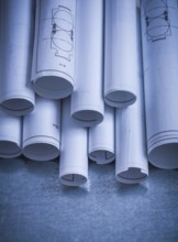 Heap of engineering drawings on scratched metallic background building and architecture concept