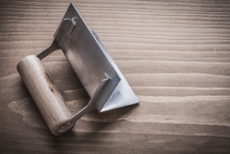 Single angle former with wood handle on wooden board