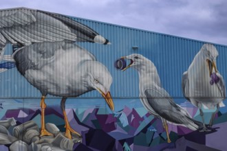 Large mural of seagulls picking up rubbish, an artistic representation of recycling, Hamburg