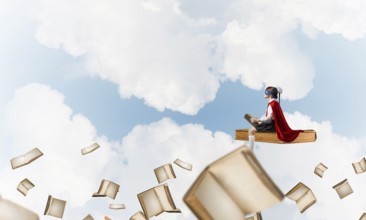 Girl power concept with cute kid guardian against cloudscape background