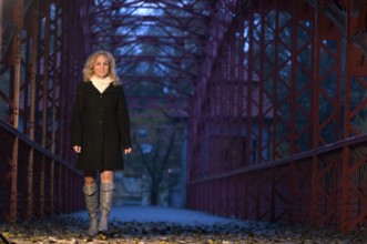 Portrait of a middle-aged, curly-haired blonde woman at dusk