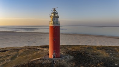 Aerial view of the northern end of the island of Texel with beach and lighthouse in sunshine, De