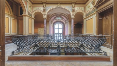 Historic balcony in an empty room with wrought-iron railings and columns, Villa Woodstock, Lost