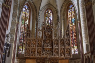 Detailed altarpiece with colourful church windows in Gothic style, schleswig, germany