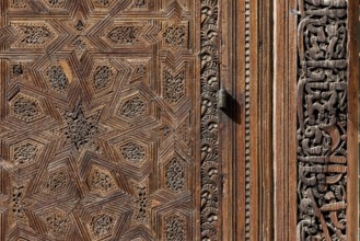 Traditional oriental door detail at the courtyard of madrasa Bou Inaniya in the medina of Fes,