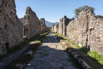 POMPEII, ITALY, MAY 04, 2022, A beautiful typical cobbled street in the ancient city of Pompeii,