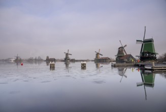 Windmills along the river Zaan in the Dutch traditional village Zaanse Schans which is one of the