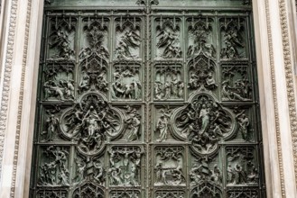 Entrance bronze door to the Duomo. Milan, Italy.