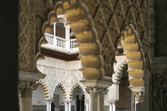 View through an archway into the inner courtyard of the Alcazar in Seville