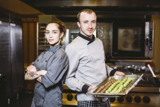 Profession preparation confectionery products. Caucasian man and woman two employees colleague