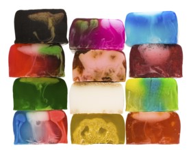 Set of several handicraft coloured nice cream soap bars in stack isolated on white background