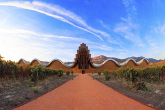 The magnificent modern architecture of Bodegas Ysios. Bright flaming colors of the sunset. Journey