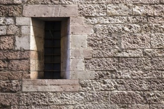 Assisi Italy : Window on medieval stone wall