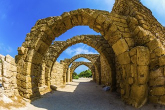Picturesque ruins of the ancient seaport Caesarea. Excursion to the Archaeological Park of the