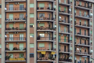 View of a facade of coloured flats with balconies
