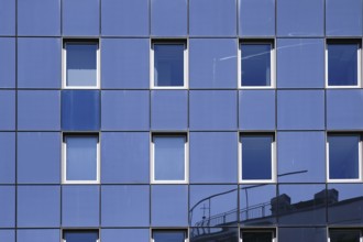 The reflection of buildings in the modern mirror façade of an office and residential building