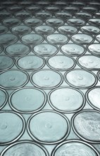 Green window with circular panes of swirled glass. Shallow depth of field