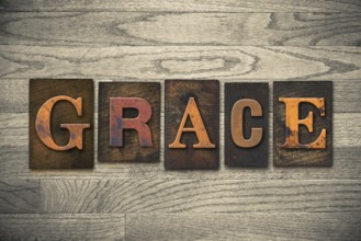 The word GRACE written in wooden letterpress type