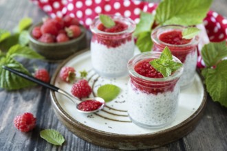 Healthy breakfast. Glass jars with chia pudding with raspberry and jam or smoothies with chia seeds