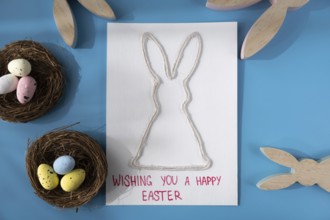 Handmade greeting card with EASTER bunny HAPPY EASTER written in beautiful handwriting. Gesture