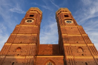 The two towers of the Church of Our Lady in the historic centre of Munich in front of a clear cloud