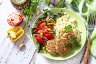 Healthy vegan food, keto or paleo diets. Homemade red fish cutlets with bulgur and fresh vegetable
