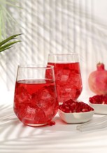 Pomegranate fruit juice and ingredients, summer pomegranate drink on bright table, detox diet and