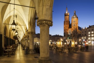 City of Krakow by night in Poland, Main Square in the Old Town with St. Mary Church from the arcade