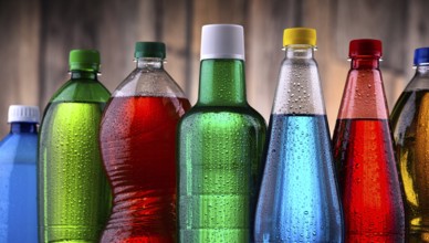 Plastic bottles of assorted carbonated soft drinks in variety of colors