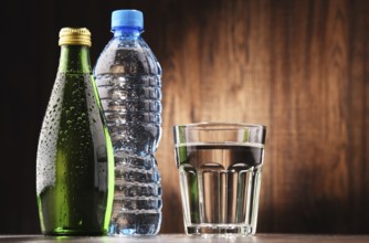 Composition with glass and bottles of mineral water